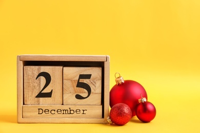 Photo of Wooden block calendar and decor on color background. Christmas countdown