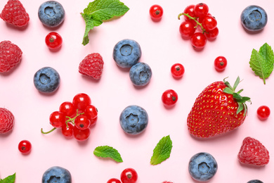 Photo of Different fresh berries on pink background, flat lay