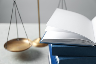 Photo of Scales of justice and books on table. Law concept