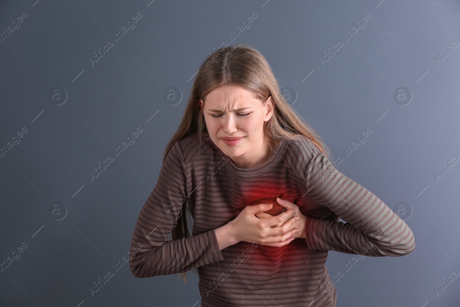 Photo of Young woman having heart attack on gray background