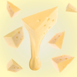 Pieces of cheese falling on yellow background