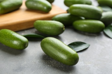 Photo of Whole seedless avocados on grey table, closeup
