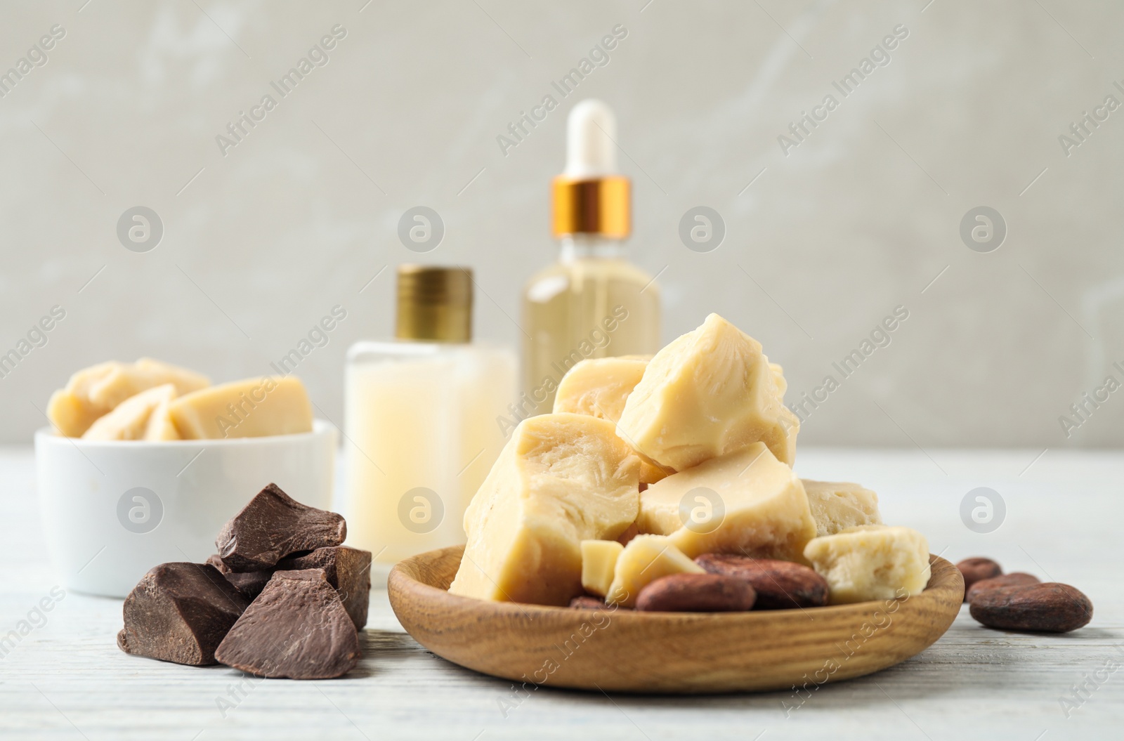 Photo of Organic cocoa butter on white wooden table
