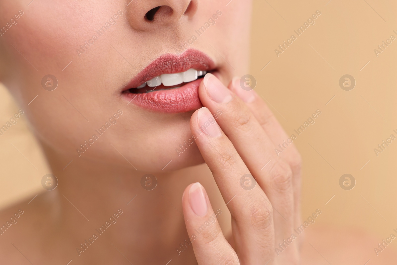 Photo of Woman with beautiful lips on beige background, closeup