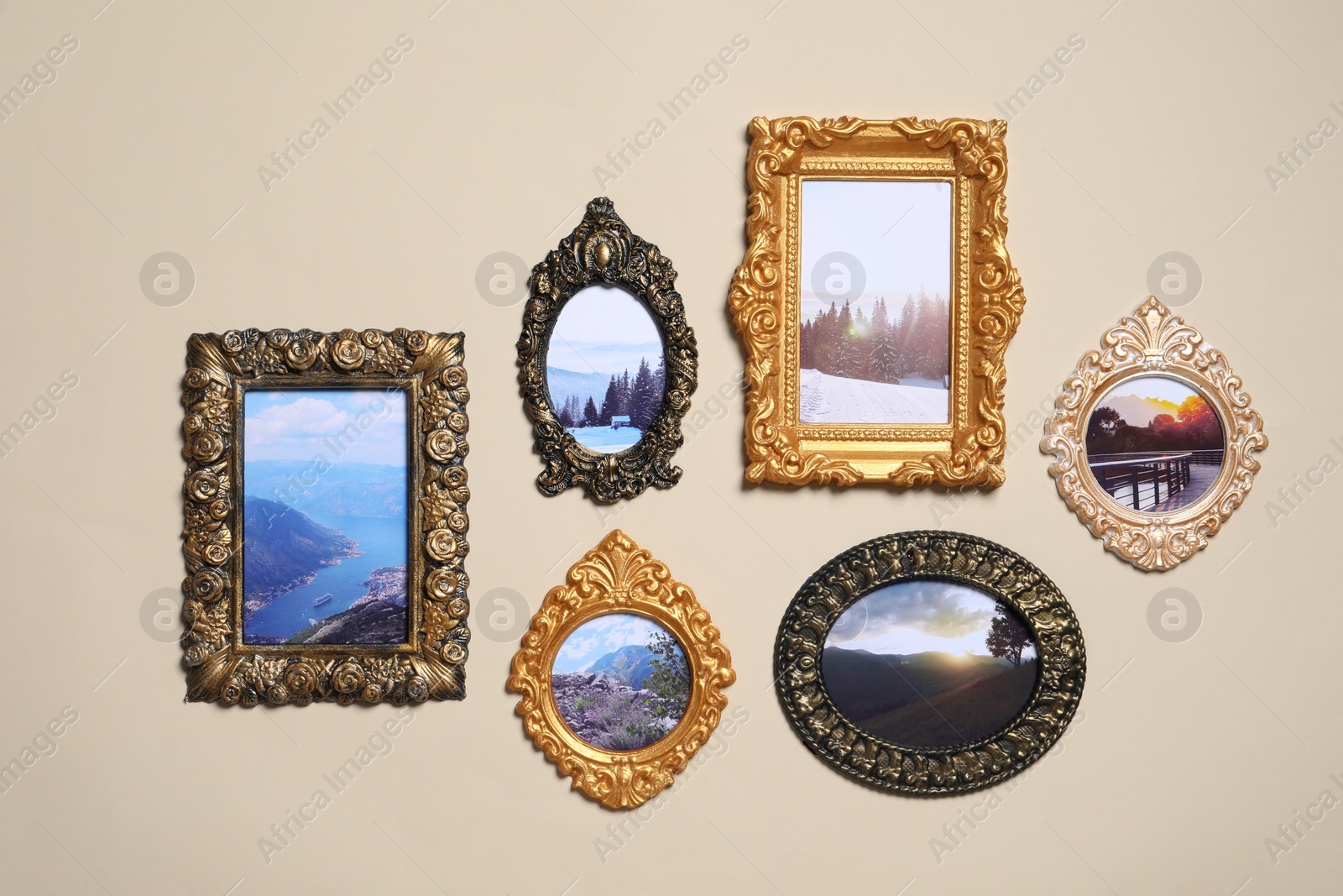 Photo of Vintage frames with photos of beautiful landscapes hanging on beige wall