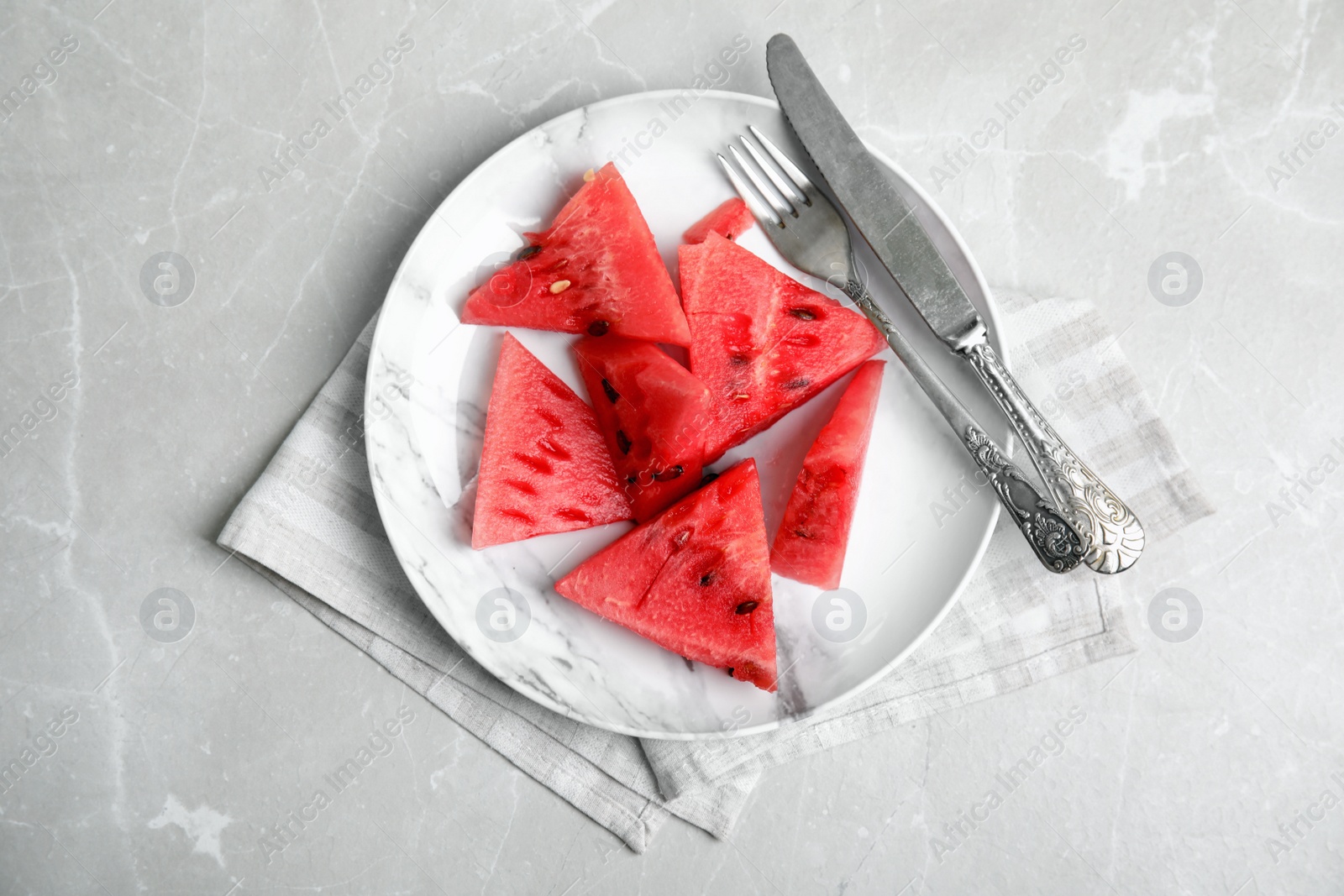 Photo of Yummy watermelon slices on grey table, top view