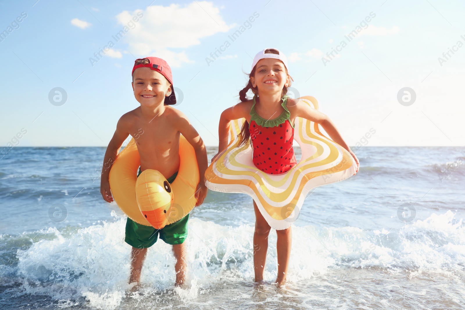 Photo of Cute children enjoying sunny day at beach. Summer camp