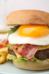 Photo of Delicious burger with fried egg on blurred background, closeup