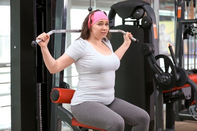 Overweight woman training in gym