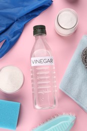 Photo of Eco friendly natural cleaners. Flat lay composition with bottle of vinegar on pink background