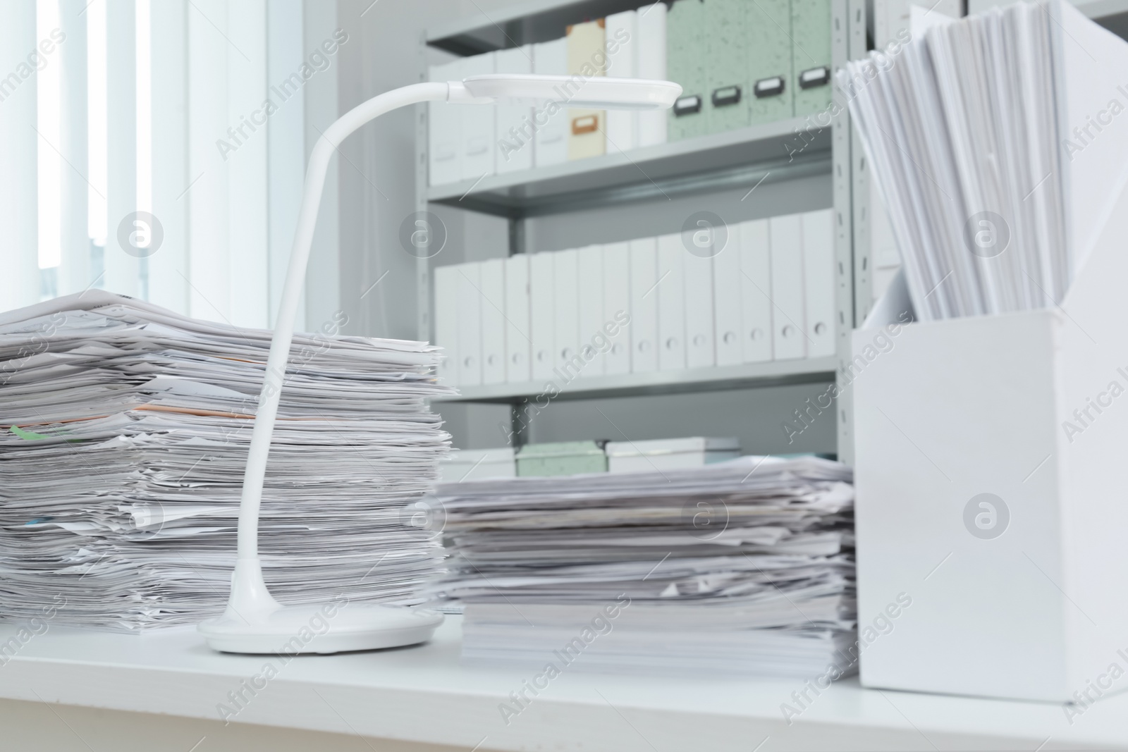 Photo of Stacks of documents on table in office