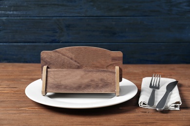 Wooden sign RESERVED on table in restaurant