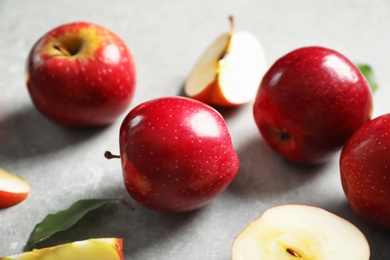 Fresh ripe red apples on light grey background