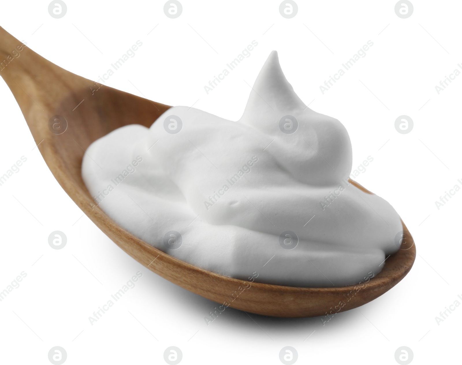 Photo of Wooden spoon with sour cream isolated on white