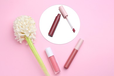 Photo of Different lip glosses, hyacinth and mirror on pink background, flat lay