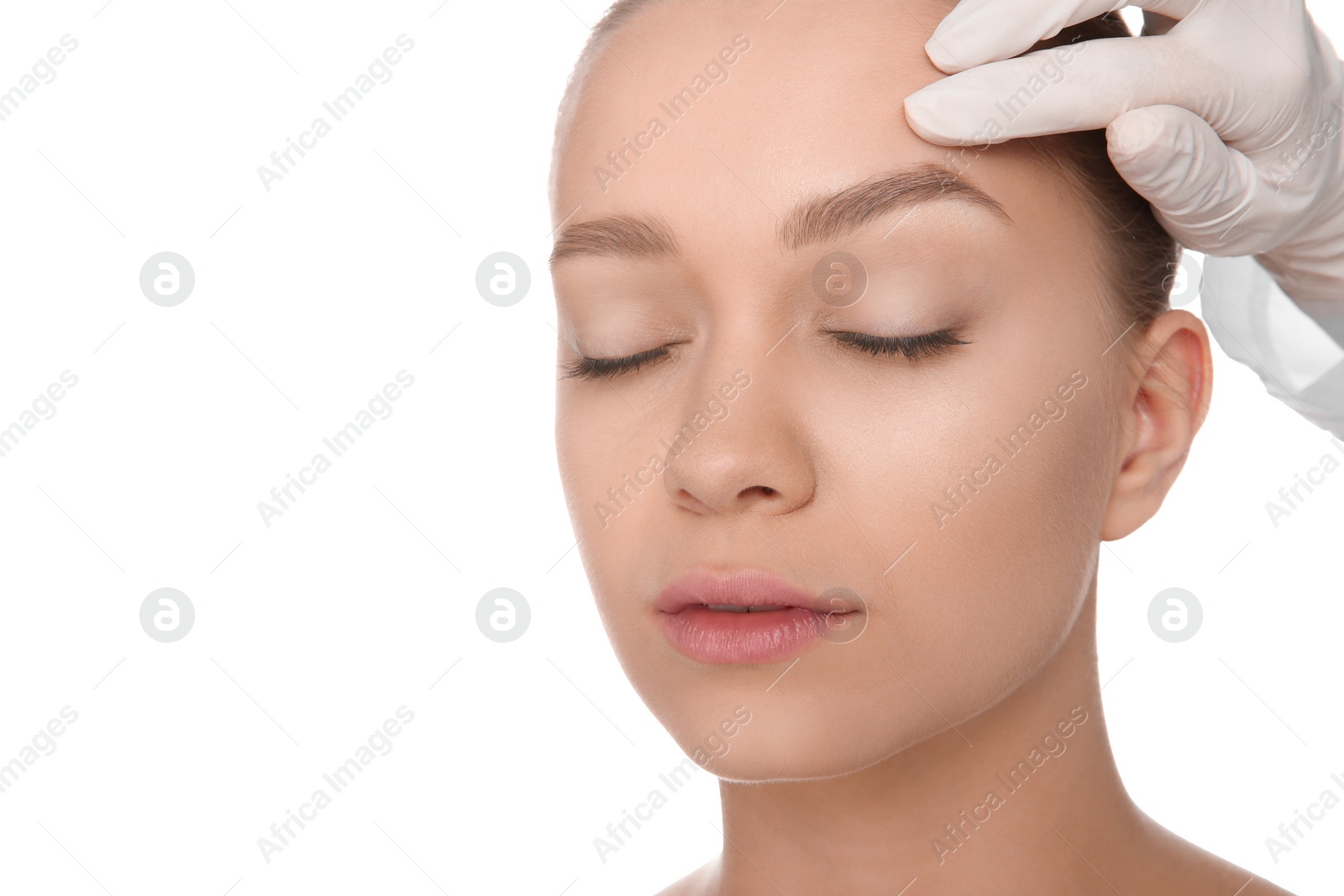 Photo of Doctor examining young woman face before cosmetic surgery on white background