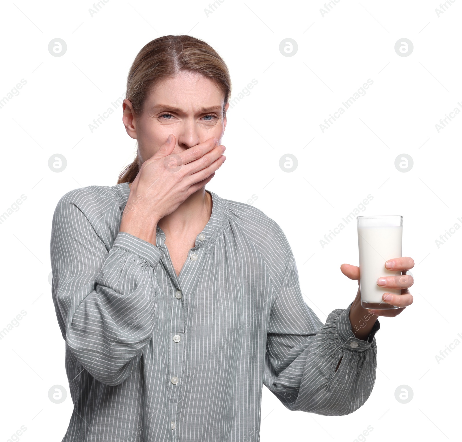 Photo of Woman with glass of milk suffering from lactose intolerance on white background