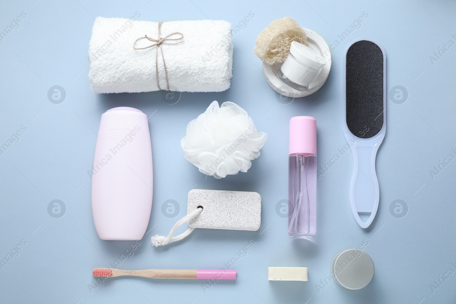 Photo of Bath accessories. Flat lay composition with personal care products on light blue background