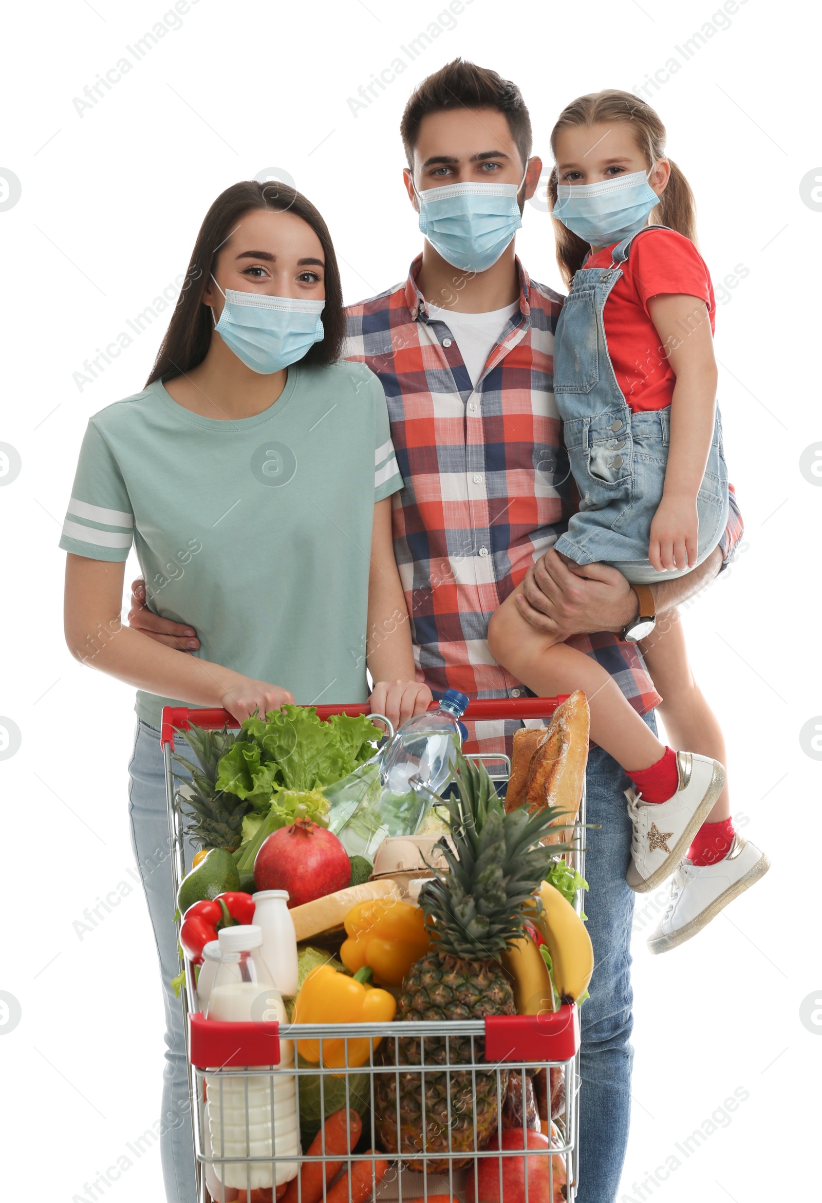 Photo of Family in medical masks with shopping cart full of groceries on white background