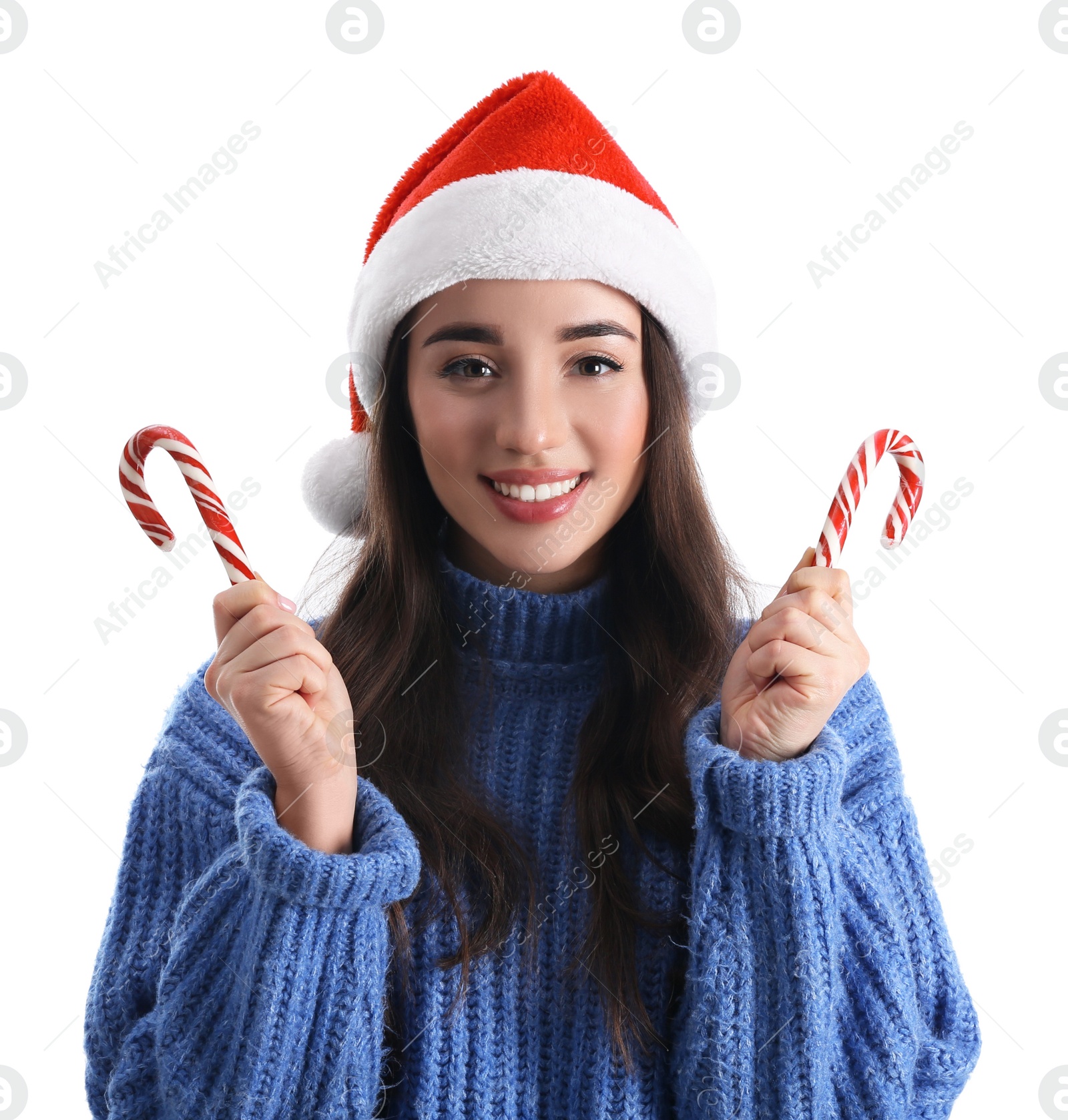 Photo of Beautiful woman in Santa Claus hat holding candy canes on white background