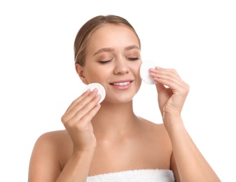 Photo of Beautiful young woman with cotton pads on white background