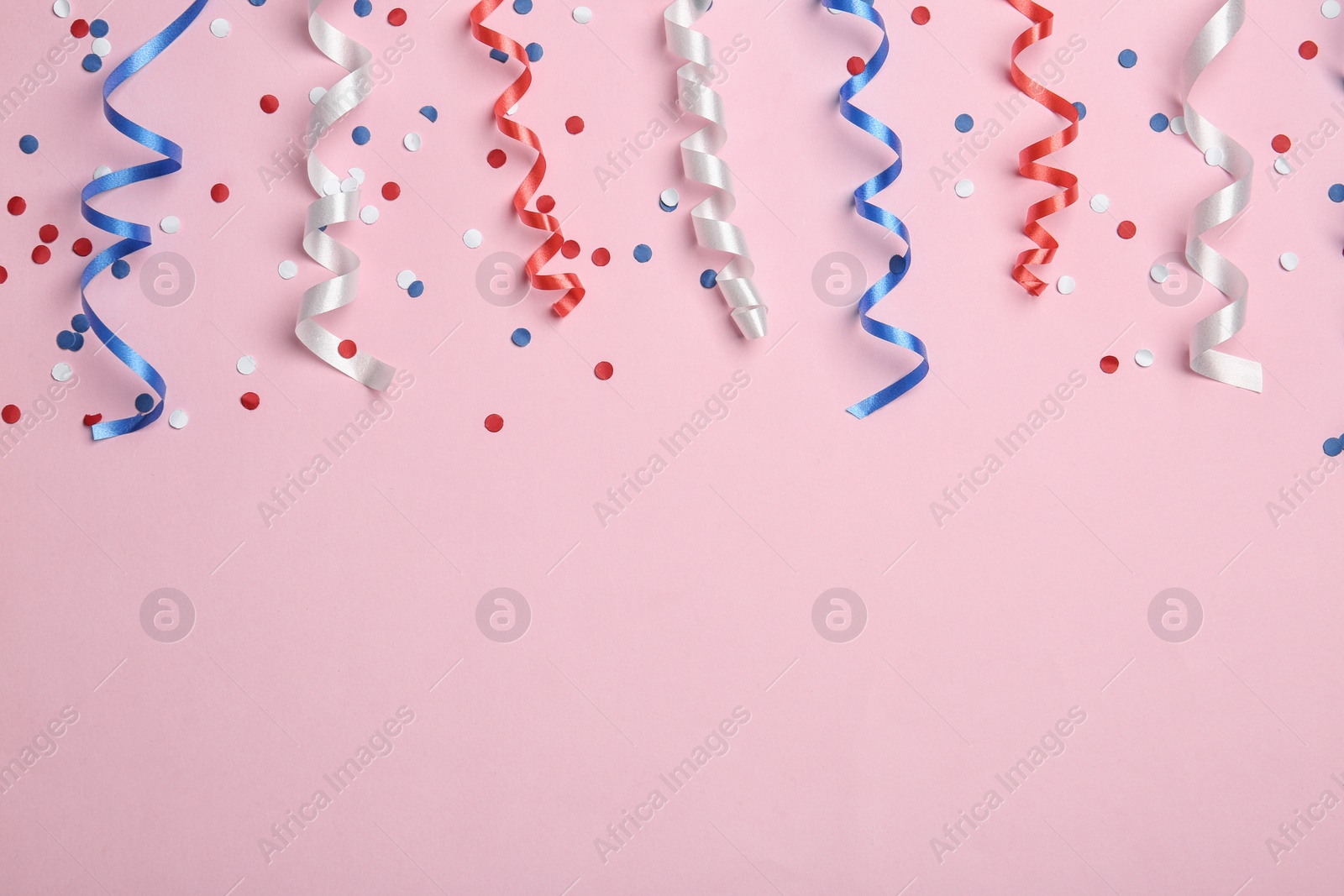 Photo of Flat lay composition with party streamers on color background, space for text. USA Independence Day
