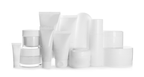 Blank tubes and jars of cosmetic products on white background