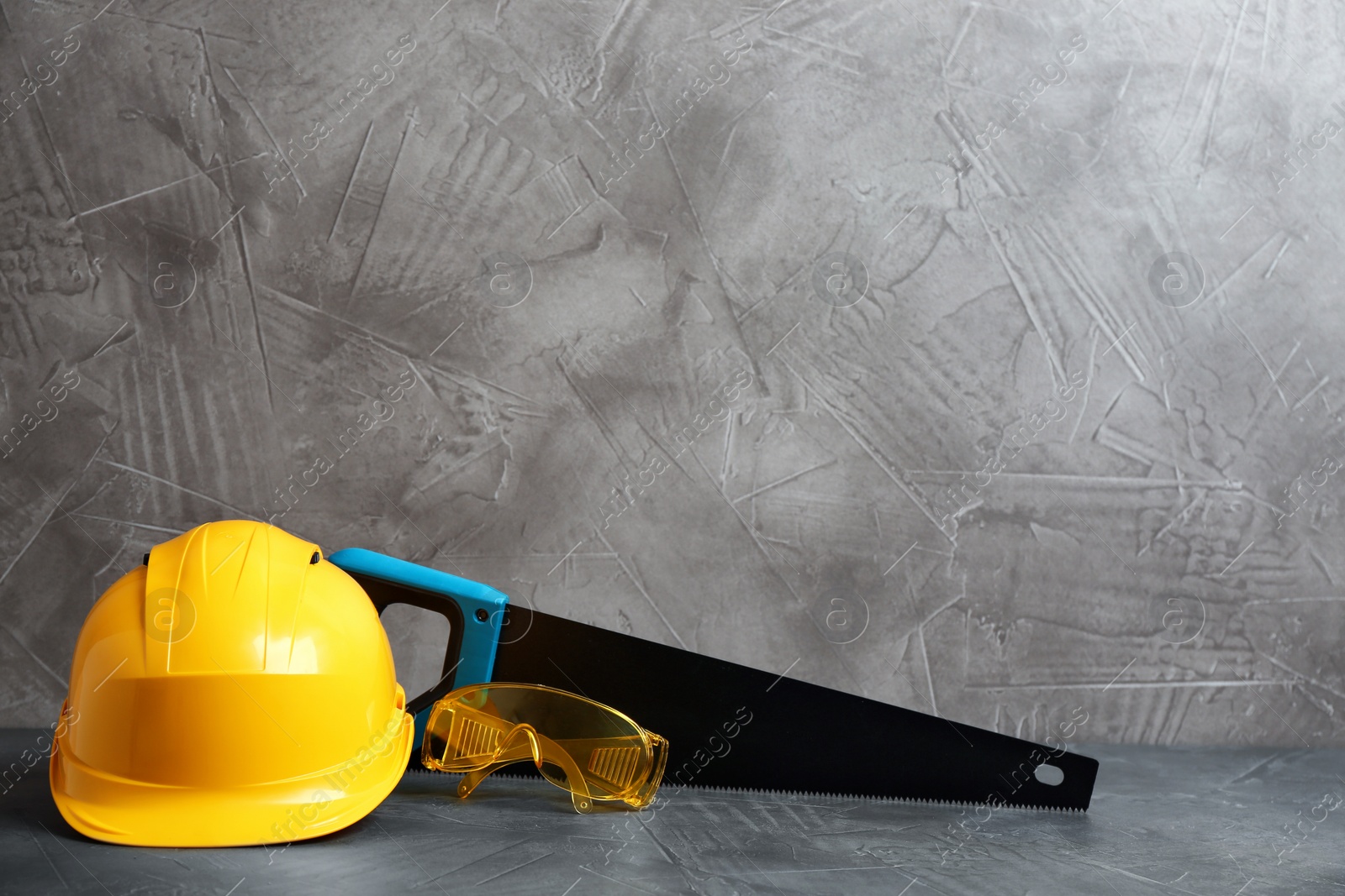 Photo of Composition with construction tools on grey table, space for text