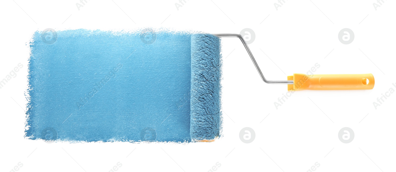 Photo of Applying light blue paint with roller brush on white background, top view