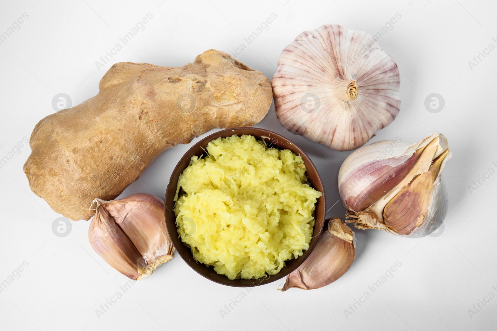 Photo of Fresh garlic and ginger isolated on white, top view. Natural cold remedies