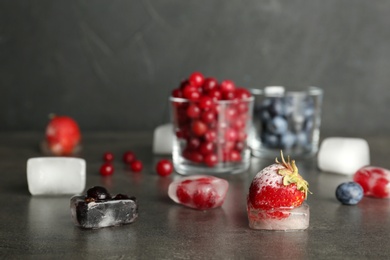 Photo of Different frozen berries on gray table