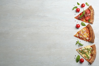 Photo of Slices of different delicious pizzas on light grey table, flat lay. Space for text