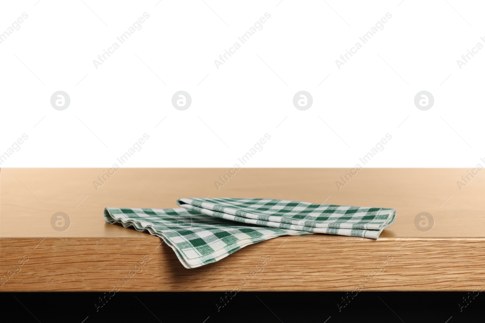 Photo of Checkered tablecloth on wooden table against white background