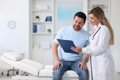 Photo of Professional doctor working with patient in hospital, space for text