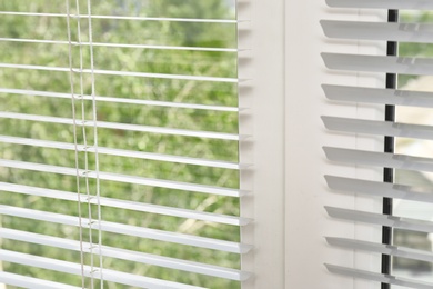 Window with open modern horizontal blinds indoors, closeup