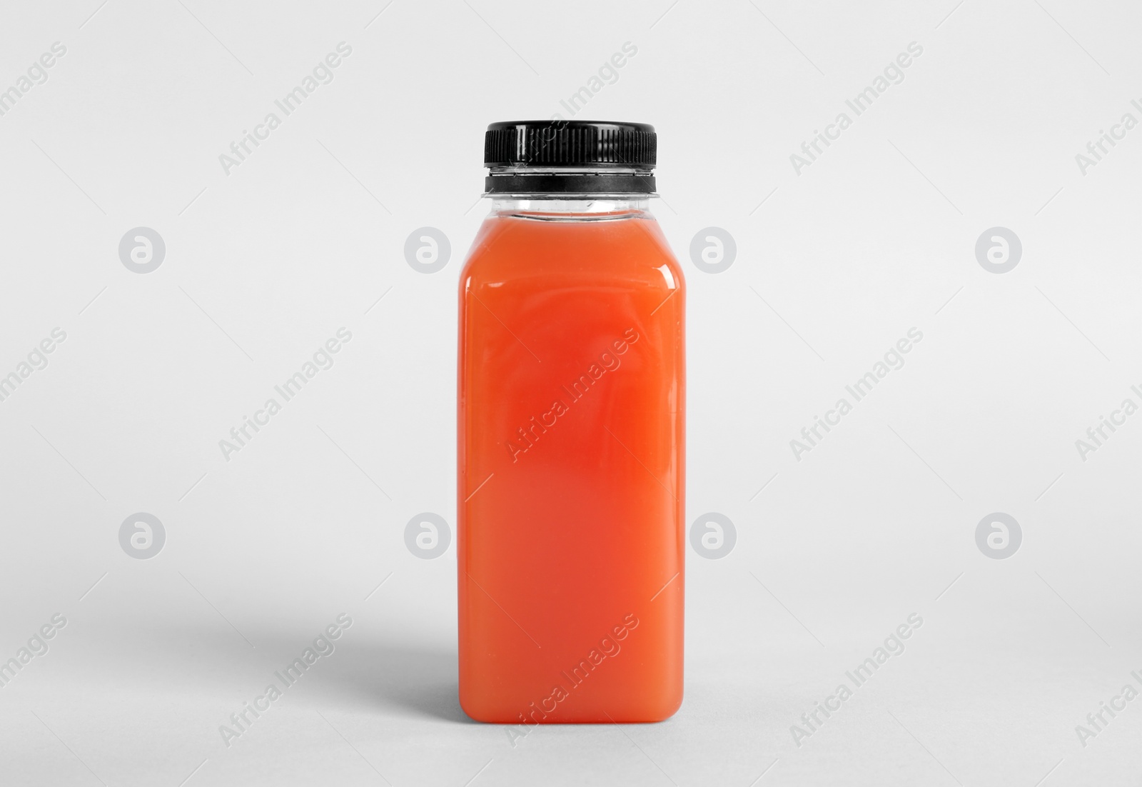 Photo of Bottle with delicious fresh juice on light background