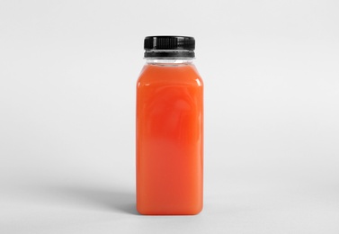 Bottle with delicious fresh juice on light background