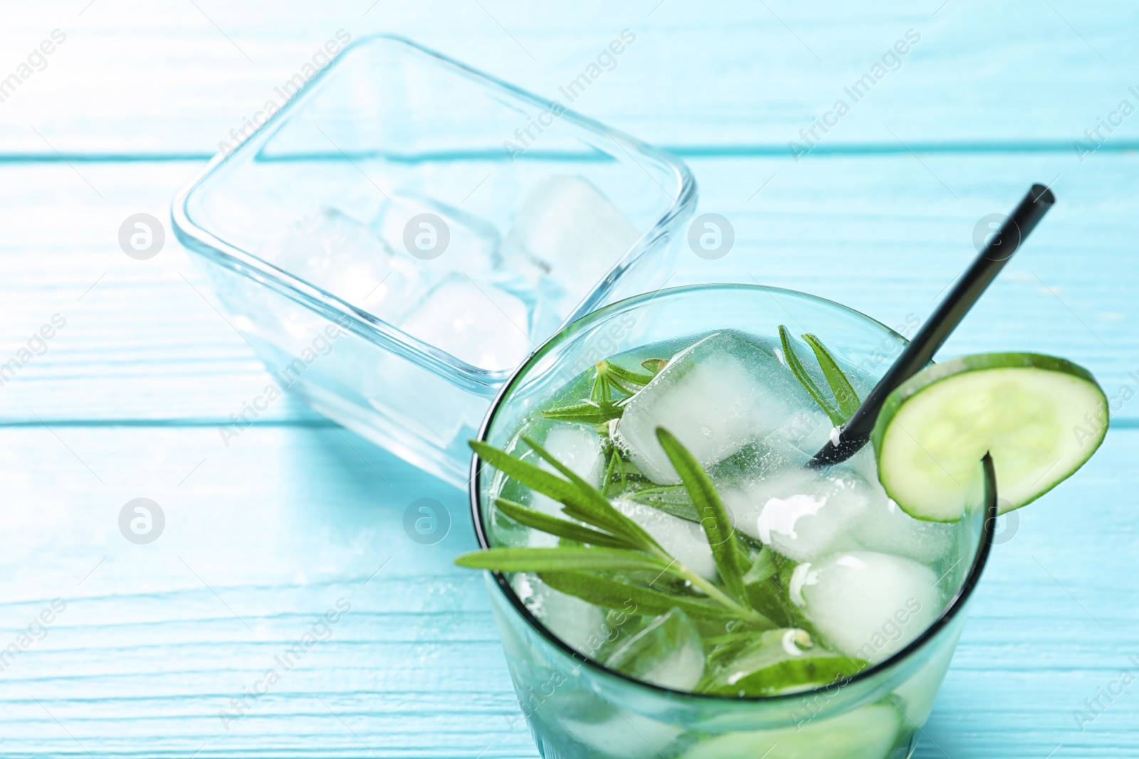 Photo of Natural lemonade with cucumber in glass on table, closeup