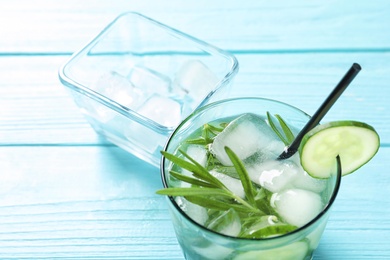 Natural lemonade with cucumber in glass on table, closeup