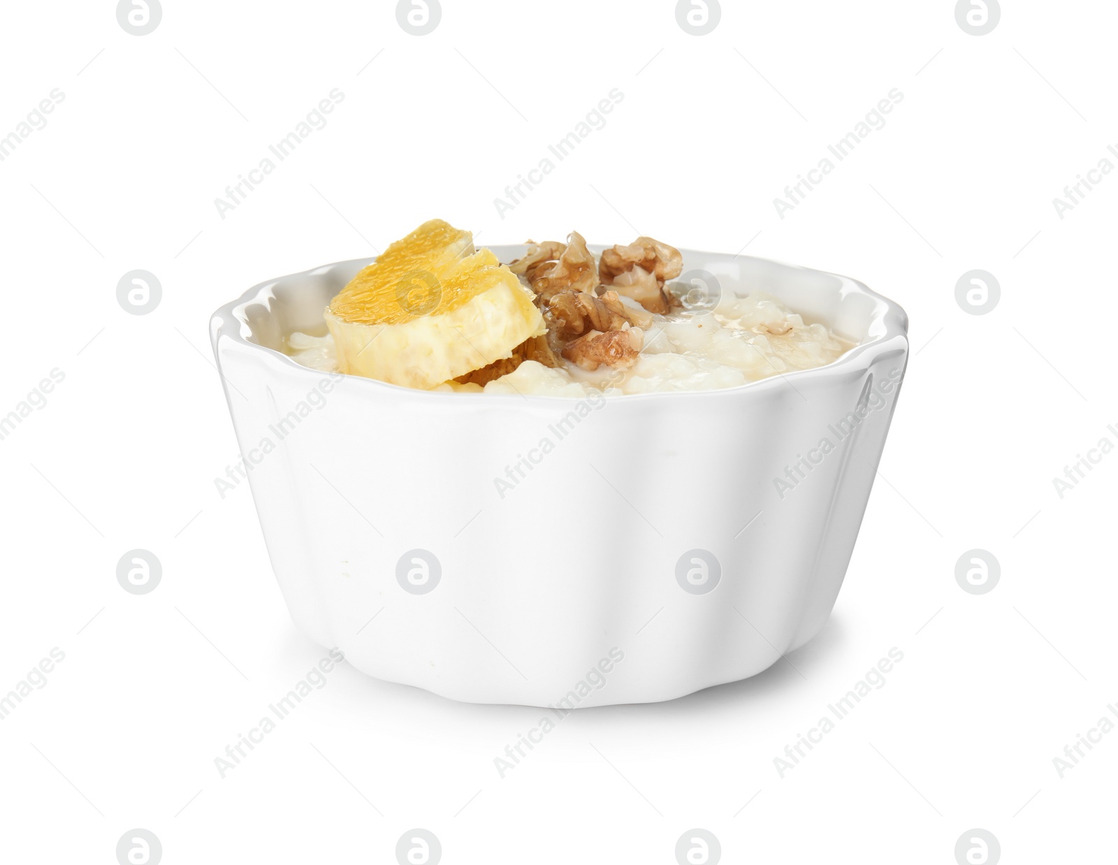 Photo of Creamy rice pudding with orange slice and walnuts in ramekin on white background