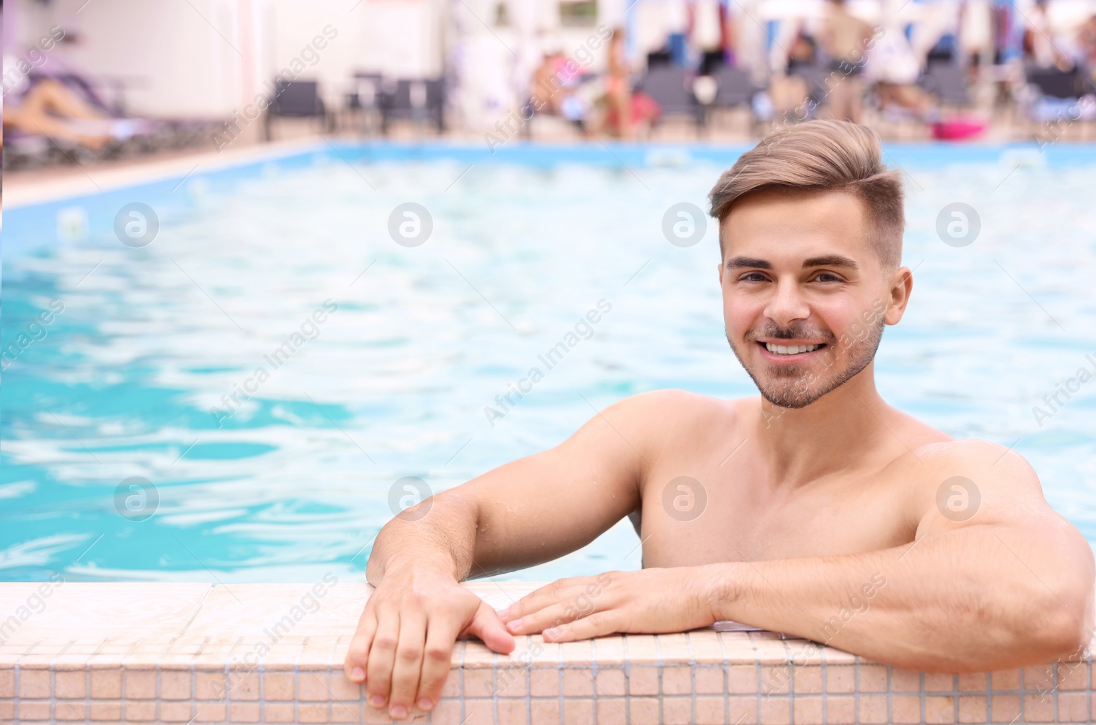 Photo of Young man in pool on sunny day