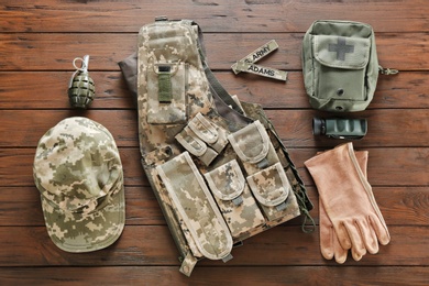 Set of military outfit on wooden background, flat lay