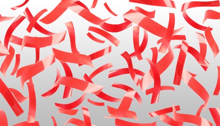 Image of Bright red confetti falling on gradient grey background. Banner design