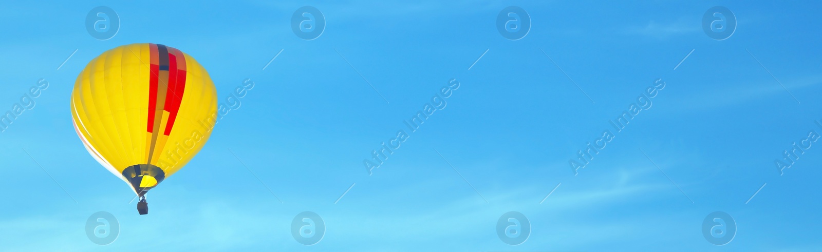 Image of Hot air balloon in blue sky, space for text. Banner design 