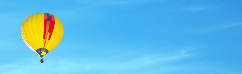 Image of Hot air balloon in blue sky, space for text. Banner design 