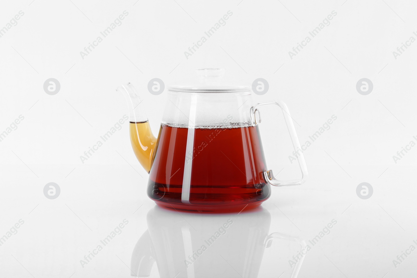 Photo of Tasty tea in teapot on white background