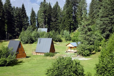 Photo of Many beautiful houses near forest in mountains