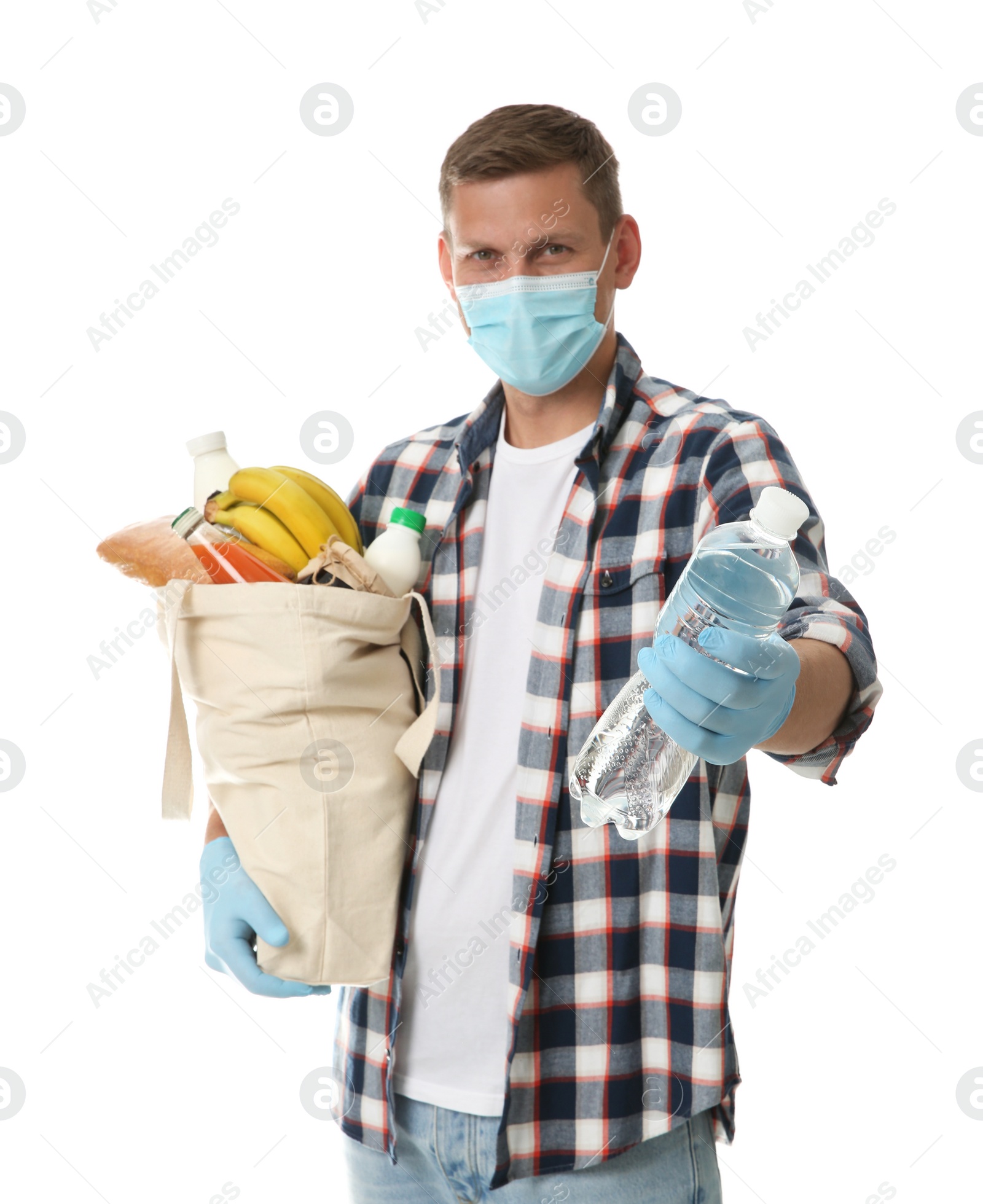 Photo of Male volunteer in protective mask and gloves with products on white background. Aid during coronavirus quarantine