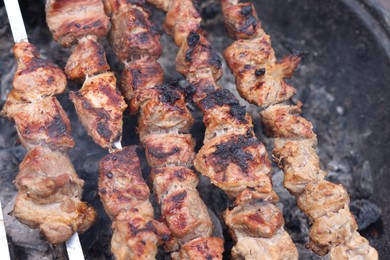 Cooking delicious kebab on metal brazier, above view