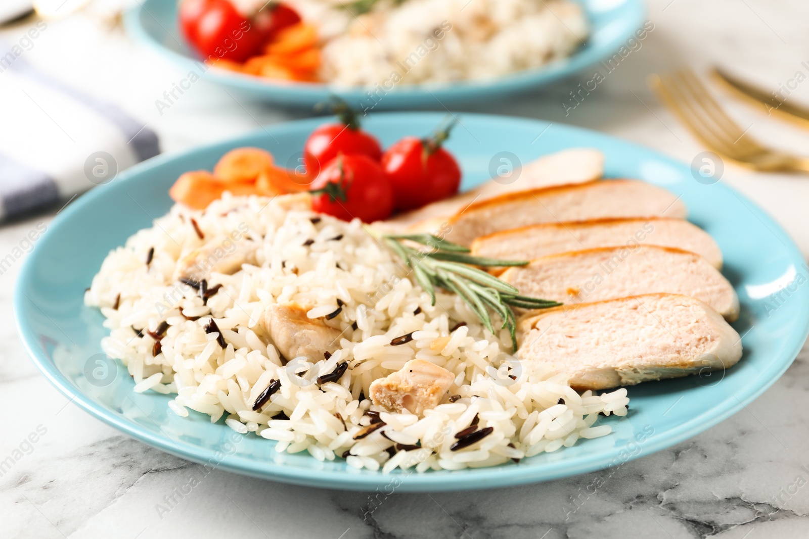 Photo of Delicious rice with chicken served on marble table